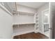 Organized walk-in closet with hardwood floors and custom shelving at 698 Magnolia Acres Ln, Fuquay Varina, NC 27526