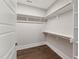 Walk in closet with custom built in shelving and hardwood floors at 698 Magnolia Acres Ln, Fuquay Varina, NC 27526
