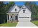 Charming two-story home featuring a two-car garage, covered porch, and well-manicured lawn at 698 Magnolia Acres Ln, Fuquay Varina, NC 27526