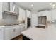 Modern kitchen boasts white cabinets, stainless steel appliances, and stylish backsplash at 698 Magnolia Acres Ln, Fuquay Varina, NC 27526