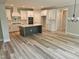 Bright kitchen features white cabinets, a spacious island, modern appliances, and wood-look floors at 698 Magnolia Acres Ln, Fuquay Varina, NC 27526