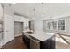 Bright kitchen featuring white cabinets, stainless appliances, and a dark island at 698 Magnolia Acres Ln, Fuquay Varina, NC 27526