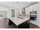 Kitchen island with marble countertops, a faucet, and stainless steel appliances at 698 Magnolia Acres Ln, Fuquay Varina, NC 27526