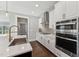 Kitchen featuring modern stainless steel appliances and white cabinetry at 698 Magnolia Acres Ln, Fuquay Varina, NC 27526