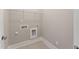 Convenient laundry room with tiled floors, shelving and washer-dryer hookups at 698 Magnolia Acres Ln, Fuquay Varina, NC 27526