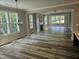 Spacious living room with wood-look floors, fireplace, and abundant natural light at 698 Magnolia Acres Ln, Fuquay Varina, NC 27526