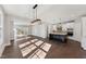 Open-concept living room flowing into a kitchen with stainless steel appliances at 698 Magnolia Acres Ln, Fuquay Varina, NC 27526