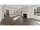 Open-concept living room featuring dark hardwood floors and a fireplace at 698 Magnolia Acres Ln, Fuquay Varina, NC 27526
