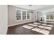 Open-concept living area with fireplace, large windows, and access to the back deck at 698 Magnolia Acres Ln, Fuquay Varina, NC 27526