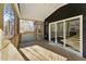 Screened in back porch with wood flooring and railings at 698 Magnolia Acres Ln, Fuquay Varina, NC 27526