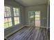 Cozy sunroom with views of the backyard and access to the outdoor deck at 698 Magnolia Acres Ln, Fuquay Varina, NC 27526