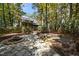 Landscaped backyard with fire pit and wooden deck at 7925 S Highway 55, Willow Springs, NC 27592