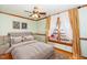Bedroom with hardwood floors and virtually staged bed at 7925 S Highway 55, Willow Springs, NC 27592