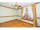 Hardwood floor bedroom with ceiling fan and window seat at 7925 S Highway 55, Willow Springs, NC 27592