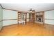 Spacious living room featuring hardwood floors, a brick fireplace, and built-in shelving at 7925 S Highway 55, Willow Springs, NC 27592