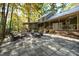 Large stone patio with seating area and fire pit at 7925 S Highway 55, Willow Springs, NC 27592