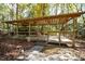 Wooden pergola with open sides and stone path at 7925 S Highway 55, Willow Springs, NC 27592