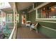 Side porch with seating and view into the kitchen at 7925 S Highway 55, Willow Springs, NC 27592