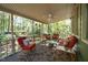 Relaxing covered porch with seating and wooded views at 7925 S Highway 55, Willow Springs, NC 27592