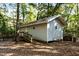 Small, raised house with ramp access in wooded area at 7925 S Highway 55, Willow Springs, NC 27592