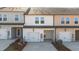 New construction townhomes showcase garages, covered patios, and varied neutral color schemes at 955 Alma Railway Dr # 563, Wake Forest, NC 27587
