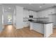 Modern kitchen featuring white cabinets, granite countertops, and stainless steel appliances at 955 Alma Railway Dr # 563, Wake Forest, NC 27587