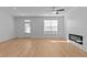 Bright living room open to the kitchen, with hardwood floors and a modern fireplace at 955 Alma Railway Dr # 563, Wake Forest, NC 27587