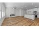 Open floor plan showcasing a modern fireplace, hardwood floors, and a stylish kitchen at 955 Alma Railway Dr # 563, Wake Forest, NC 27587