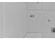 Minimalist utility room featuring white walls, a white tile floor, and basic hookups at 955 Alma Railway Dr # 563, Wake Forest, NC 27587