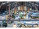 Spacious interior with high ceilings and a steel frame supporting the roof and exposed pendant lighting fixtures at 10 Seawell Ave # 102, Raleigh, NC 27601