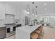 Stylish open-concept kitchen with a marble island, stainless steel appliances, and modern lighting at 10 Seawell Ave # 102, Raleigh, NC 27601
