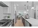 Bright, open kitchen with stainless steel appliances, an island with seating, and a view to the living area at 10 Seawell Ave # 102, Raleigh, NC 27601