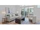 Bright living room with a comfortable sofa, textured rug, and sliding glass doors to a private balcony at 10 Seawell Ave # 102, Raleigh, NC 27601