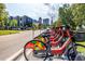 Citrix Cycle rental bicycles stand in a neat row along the street against the backdrop of city buildings at 10 Seawell Ave # 102, Raleigh, NC 27601