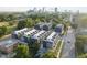 Stunning aerial view of modern townhomes with a cityscape backdrop, surrounded by lush greenery at 10 Seawell Ave # 105, Raleigh, NC 27601
