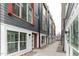 View down a sidewalk between rows of new townhomes with gray siding and white trim at 10 Seawell Ave # 105, Raleigh, NC 27601