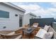 Rooftop deck with stylish furniture, wood plank flooring and a door to enter the home at 10 Seawell Ave # 105, Raleigh, NC 27601