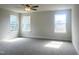 Bedroom features neutral carpeting, large windows and a ceiling fan at 240 Fast Pitch Ln, Four Oaks, NC 27524