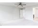 Bedroom with neutral carpet, ceiling fan, and bathroom and bedroom doors at 240 Fast Pitch Ln, Four Oaks, NC 27524