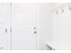 Bright entryway featuring a white door with hooks, a bench, and convenient storage space at 240 Fast Pitch Ln, Four Oaks, NC 27524