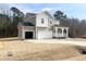 Charming two-story home with a covered porch, two-car garage, and a well-maintained lawn at 240 Fast Pitch Ln, Four Oaks, NC 27524