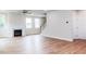 Bright living room featuring a fireplace, wood floors, and neutral paint at 240 Fast Pitch Ln, Four Oaks, NC 27524