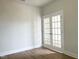 Bright living room featuring a glass paneled door, hardwood floors, neutral paint, and white trim at 240 Fast Pitch Ln, Four Oaks, NC 27524