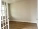 Bright open floor plan with hardwood floors, a glass paneled door, and neutral paint throughout at 240 Fast Pitch Ln, Four Oaks, NC 27524