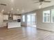 Bright living room featuring hardwood floors, an open floor plan, and a modern kitchen at 240 Fast Pitch Ln, Four Oaks, NC 27524