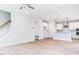 Open concept living space with a kitchen and living room, featuring wood floors and neutral paint at 240 Fast Pitch Ln, Four Oaks, NC 27524