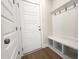 Charming mudroom features board and batten wainscoting, bench seating, and coat hooks at 240 Fast Pitch Ln, Four Oaks, NC 27524