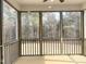 A screened porch with wood flooring and screens offer views of the surrounding woods at 240 Fast Pitch Ln, Four Oaks, NC 27524