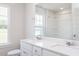 Bright bathroom featuring double sinks, white cabinets and quartz countertops at 266 Fast Pitch Ln, Four Oaks, NC 27524
