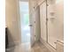 Bathroom showcasing tiled walk-in shower with a glass door and neutral color palette at 266 Fast Pitch Ln, Four Oaks, NC 27524
